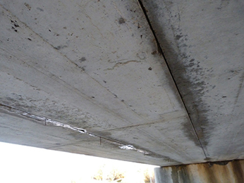 Photograph of the underside of a bridge, showing pre-stressed concrete box beams
